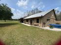 Side view of exterior with a covered parking area and outdoor spa at 1464 Mount Pleasant Rd, Groveland, FL 34736