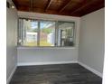 Bright sunroom with wood-planked ceiling and large windows providing natural light and views of the surrounding landscape at 213 5Th Jpv St, Winter Haven, FL 33880