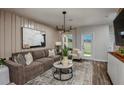 Comfortable living room with stylish decor, plush seating, and a modern chandelier at 3856 King Hill Dr, Haines City, FL 33844