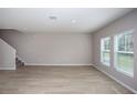 Spacious living area features wood-style floors and natural light through large windows at 4043 Gardenia Ave, Lake Hamilton, FL 33851