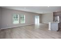 Open-concept living space with light wood floors and natural light provides a welcoming atmosphere at 4043 Gardenia Ave, Lake Hamilton, FL 33851