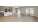 Spacious open-concept living area with modern gray kitchen, stainless appliances, and bright, natural light at 4075 Gardenia Ave, Lake Hamilton, FL 33851