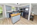 Modern kitchen boasts stylish gray cabinets, stainless steel appliances, and functional center island at 2937 Delrose N Dr, Lakeland, FL 33805