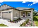 Home showcasing a side entry with a plum colored door and lovely landscaping at 3183 Seville St, Lake Alfred, FL 33850