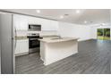 Modern kitchen boasts stainless steel appliances, granite countertops, and island at 3183 Seville St, Lake Alfred, FL 33850