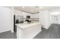 Modern kitchen featuring stainless steel appliances, granite countertops, and a center island at 3736 Bergamot St, Lake Alfred, FL 33850