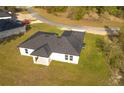 Aerial view showcases the modern single-Gathering home's dark roof and well-maintained lawn at 12921 Sw 64Th Terr Rd, Ocala, FL 34473