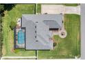 Aerial view showcasing the roof, large pool, well-maintained landscaping and circular driveway with a fountain feature at 5144 Riverlake Dr, Bartow, FL 33830