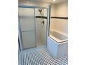 Bathroom featuring a glass-enclosed shower and a tiled jacuzzi tub, providing a spa-like feel at 5580 Hwy 542 W, Winter Haven, FL 33880