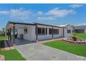 Exterior view of a modern home with a covered parking area and well-maintained landscaping at 1475 3Rd Ave, Deland, FL 32724