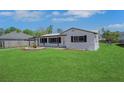 Inviting single-story home with a lush green lawn and a charming front yard garden at 1475 3Rd Ave, Deland, FL 32724