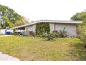 A single story home with xeriscape landscaping including succulents and cacti in the front yard at 2908 Maplewood Ave, Lakeland, FL 33803