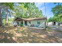 Single-story home with brick exterior, covered entry, mature trees, and long driveway for plenty of parking at 3365 Bahama Ct, Lake Wales, FL 33898