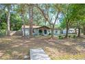 Inviting single-story home with a front porch and brick exterior nestled among mature trees on a spacious lot at 3365 Bahama Ct, Lake Wales, FL 33898