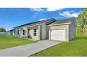 Stylish home with a one-car garage and a concrete driveway on a sunny day at 534 S Perry Ave, Fort Meade, FL 33841