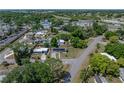Birds eye view of a neighborhood featuring tree-lined streets and a single-Gathering home with solar panels at 3928 Cherry Way, Lakeland, FL 33805
