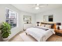 Cozy bedroom features natural light from a window, a comfy bed and stylish decor and a ceiling fan at 490 N Pin Oak Pl # 112, Longwood, FL 32779