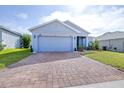 Exterior shot showcasing the driveway, lush lawn, and tidy landscaping around the house at 670 Campo Ln, Davenport, FL 33837