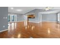 Spacious living room with hardwood floors leading to the kitchen and lanai at 114 Valencia Loop, Altamonte Springs, FL 32714