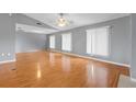 Bright and airy living room featuring hardwood floors, ceiling fan and natural light at 114 Valencia Loop, Altamonte Springs, FL 32714