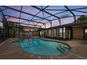 Inviting screened-in pool with brick trim and view of sunset at 114 Valencia Loop, Altamonte Springs, FL 32714