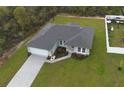 Aerial view of a well-maintained property featuring lush greenery, a spacious driveway, and a fenced yard at 16538 Sw 31St Terrace, Ocala, FL 34473