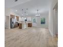 Open-concept kitchen with modern stainless steel appliances, a center island, and ample natural light at 16538 Sw 31St Terrace, Ocala, FL 34473