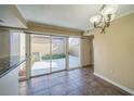Bright dining space featuring tiled floors, stylish lighting, and access to the outdoor patio at 2500 21St Nw St # 71, Winter Haven, FL 33881