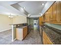 Kitchen featuring stainless appliances, decorative granite countertops, and a bar that overlooks dining area at 2500 21St Nw St # 71, Winter Haven, FL 33881