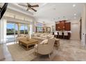 Bright living room open to kitchen with travertine floors, large windows and neutral decor at 12329 Sw 140Th Loop, Dunnellon, FL 34432