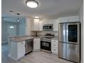 Cozy kitchen featuring stainless appliances, granite counters, and bright lighting at 2625 Williston Dr, Lakeland, FL 33801