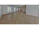 Spacious living room featuring neutral walls, tile flooring, and bright windows at 66 Alachua Dr, Winter Haven, FL 33884