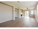 Spacious living room with wood flooring, fireplace, ceiling fan, and sliding glass doors to the lanai at 1405 Harbor Ridge Dr, Kissimmee, FL 34759