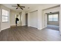 Open-concept living room boasts wood floors and entry ways to the kitchen and additional bedroom at 1405 Harbor Ridge Dr, Kissimmee, FL 34759