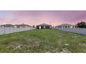Expansive backyard with a lush green lawn and a privacy fence, offering plenty of space for outdoor activities at 329 W Aster Ct, Poinciana, FL 34759