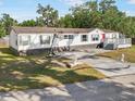 Charming single-story home features a long driveway, front basketball court, and well-maintained lawn and mature trees at 4795 Myrtle View W Dr, Mulberry, FL 33860