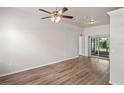 Spacious living room with light wood-look flooring and sliding glass doors at 541 Willet Cir, Auburndale, FL 33823