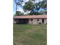 The backyard features a large lawn and a screened patio at 3400 Ne 43Rd Pl, Ocala, FL 34479