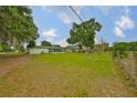 Expansive backyard featuring mature trees and ample green space at 9210 Lehall W Sq, Lakeland, FL 33810