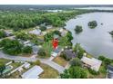 Aerial view of home near a lake surrounded by lush greenery, showcasing its waterfront community and location at 4912 Marla Ave, Lakeland, FL 33812