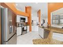 Modern kitchen with stainless steel appliances, granite countertops, and white cabinets at 4014 Gallagher Loop, Casselberry, FL 32707