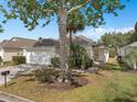 Inviting single Gathering home with a lush front lawn and driveway leading to garage at 146 Bayswater Ln, Davenport, FL 33897