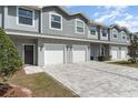 Charming townhome featuring a gray exterior, attached garage, and well-maintained landscaping at 350 N 1St Ave, Bartow, FL 33830