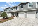 Charming townhome featuring a gray exterior, attached garage, and well-maintained landscaping at 350 N 1St Ave, Bartow, FL 33830