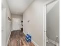 Inviting hallway featuring wood-look flooring, neutral walls, and access to a half-bathroom at 350 N 1St Ave, Bartow, FL 33830