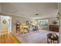 Cozy living room featuring carpet, decorative accents, and a window at 4915 Whiteoak E Dr, Lakeland, FL 33813