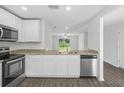 Bright kitchen with stainless steel appliances, granite countertops, and a view of the backyard at 368 Amberjack Ct, Poinciana, FL 34759