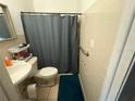 Cozy bathroom with essential fixtures, including a toilet, sink, and shower with curtain at 612 Acapulca Way, Altamonte Springs, FL 32714