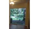 View from the living room, featuring the backyard's lush greenery visible through the sliding glass doors at 665 Oak Harbour Dr # 115, Altamonte Springs, FL 32701