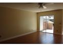 Spacious living room with hardwood floors and a sliding glass door to the outside patio, offering natural light at 665 Oak Harbour Dr # 115, Altamonte Springs, FL 32701